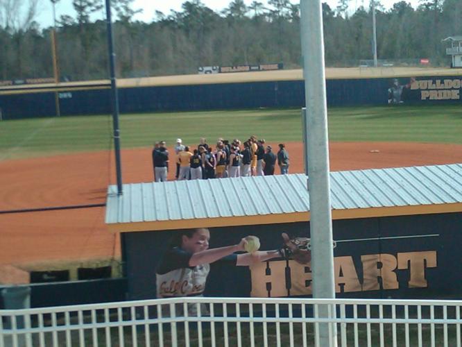 Softball team at the pitchers mound before practice.